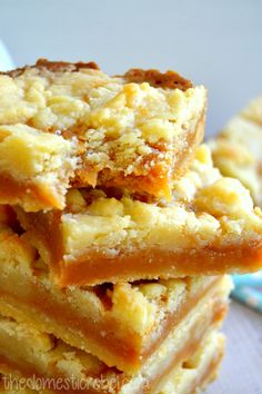 a stack of dessert bars sitting on top of a table