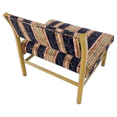 an upholstered bench with wooden legs and fabric seat padding on the back