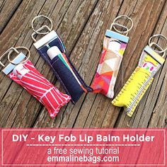 four key fobs are sitting on top of a wooden table with the words diy - key fob lip balm holder