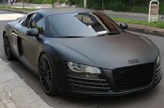 an audi sports car parked on the side of the road in front of a curb