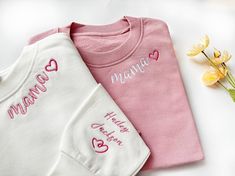 Embroidered Custom Mama Sweatshirt with Kid Name on Sleeve, Personalized Mum Sweatshirt, Mom gifts, Personalized Gifts, New Mom Gift 🌸HOW TO ORDER: Please check our size and color charts to get exactly what you want. Select the correct size and color and fill out the personalization box 🌸ABOUT OUR SWEATSHIRTS/HOODIES: 35% Cotton, 65% Polyester Machine cold wash, inside out, with like colors. Lay flat to dry. Please do not bleach. Please do not iron. Sizes are standard Unisex and run true to size. If women want a loose fit, they should order their usual size. Size down for a fitted look; size up one or two sizes for the oversized/baggy look. Please double-check our size chart to get the right size for you! 🌸Don't forget to check out the rest of our listings for more custom embroidery, an Custom Embroidered White Tops For Mother's Day, White Tops With Embroidered Graphics For Mother's Day, Embroidered White Tops For Mother's Day, White Embroidered Tops For Mother's Day, Mother's Day Crew Neck Top With Embroidered Text, Mother's Day Embroidered Text Crew Neck Top, White Tops With Letter Embroidery For Mother's Day, Pink Top With Embroidered Text As Gift, Long Sleeve T-shirt With Machine Embroidery As Gift