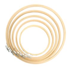 a set of four wooden hoops on a white background