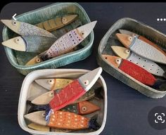 three small trays with different colored fish in them