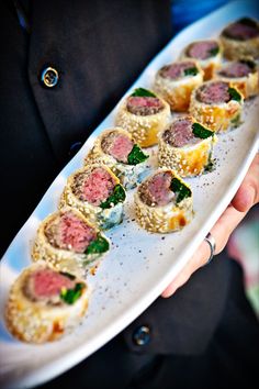 a person holding a plate with some food on it