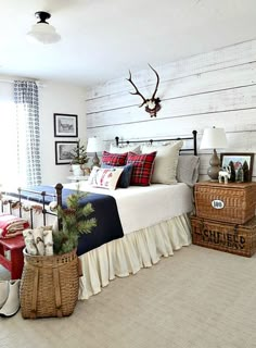 a bed room with a neatly made bed and two baskets