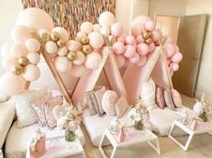 pink and gold balloons are on display in the living room, along with other decorations