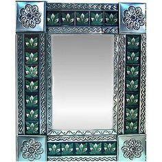 a decorative mirror with flowers and leaves painted on it's sides, in blue