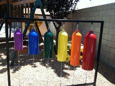 colorful fire extinguishers are hanging from a playground