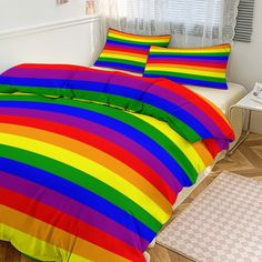 a rainbow colored bed spread with matching pillows