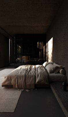 a bed sitting in the middle of a room next to a window with sunlight streaming through it