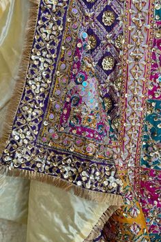 This Multicolor Heavy Embroidered Handwork Pakistani Silk Dupatta with Lining is a stunning piece with intricate handwork of sequins and pearls, a gold lined back and vibrant multi-color block print. Its 2.5 meter size makes it perfect to pair with a Lehenga or Salwar Suit. Stunning and unique, this item is ready to ship from California. Material: Silk Color: Multicolor Pattern: Floral, Block Screen Print Work: Handcrafted sequins, beads, embroidery & pearl work Size: 2.5 meter Condition: New Occasion: Festive, wedding, party Care: Dry Clean Handcrafted productsProduct Note:​ Handcrafted product from artisans and producer groups and due to the nature of the product, slight variation in colors or design may occur. Any slight irregularities are distinctive and are inherent to the beauty of t Pakistani Bridal Dupatta, Heavy Dupatta Designs Unique, Phulkari Pants, Lucknowi Kurta, Patiala Salwar Suits, Heavy Dupatta, Bridal Dupatta, Gayatri Mantra, Phulkari Dupatta