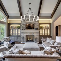 a living room filled with furniture and a fire place in the middle of a room