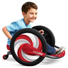 a young boy is riding on a toy bike