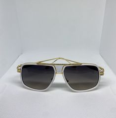 sunglasses for Men with white and gold hardware with black lens Elegant White Shield Sunglasses With Tinted Lenses, Elegant White Shield Sunglasses With Polarized Lenses, Luxury Optic White Sunglasses For Summer, Elegant White Shield Sunglasses With Uv Protection, Classic White Shield Sunglasses With Tinted Lenses, White Aviator Sunglasses With Uv Protection, White Aviator Sunglasses For Summer, Modern White Aviator Sunglasses, Gold Aviator Sunglasses For The Beach