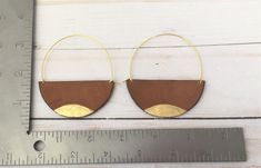 A lot of love and attention to detail went into these brown circle leather statement earrings. Leather pieces were cut into the half moon shape. Each moon was then given a tiny touch of gold paint on the bottom. The edges of the crescents were then burned to give them a darkened, rustic appearance. The ear wires were cut to length and formed into the curved shape. The ear wires are made from jeweler's bronze. These earrings measure approximately 2 5/16 x 3 inches. Thanks for checking out my earr Handmade Brown Hoop Earrings For Everyday Wear, Everyday Handmade Brown Hoop Earrings, Minimalist Brown Hoop Earrings For Gift, Nickel-free Brown Circular Earrings, Modern Small Hoop Brown Earrings, Modern Brown Small Hoop Earrings, Modern Brown Earrings With Ear Wire, Monarch Jewelry, Large Gold Earrings