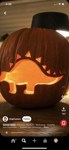 a pumpkin carved to look like a dinosaur