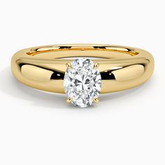 a yellow gold engagement ring with an oval cut diamond