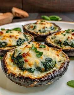 baked stuffed mushrooms with spinach and cheese on a white plate