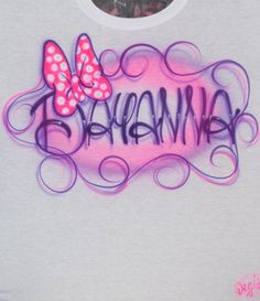 a white t - shirt with pink and purple butterflies on it that says, hawaiiana