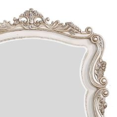 an ornate white framed mirror on a white wall