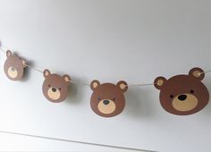 some brown teddy bears are hanging on a line