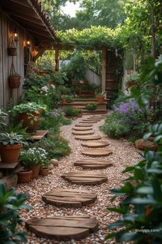 an outdoor garden with stepping stones and potted plants on either side of the walkway