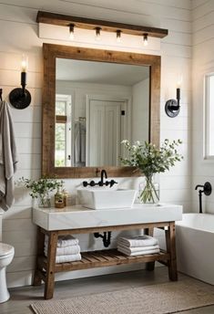 a bathroom with a sink, mirror and bathtub next to a toilet in it