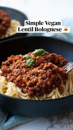 two black pans filled with spaghetti and meat sauce