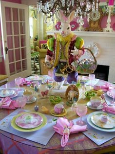 a dining room table with plates, cups and utensils on top of it