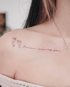 a woman's back shoulder with the words, i love you and footprints on it