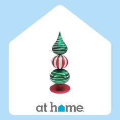 the logo for athome is displayed in front of a house with a christmas tree on it