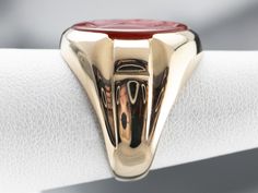 Crafted of sturdy 10 karat yellow gold, this is a classic of the Retro era. Carnelian is the reddish-orange version of chalcedony and can either be uniformly colored or have visible bands through the stone. In this case, the stone has been carved inwards, in the classic intaglio fashion, with the profile of a Roman Soldier. Metal: 10K Yellow Gold Gem: Carnelian Intaglio Gem Measurements: 15.6 x 11.9 mm, Oval Ring Size: 6.75 Marks: "KSK10K" Stamped on the inside band Mens Vintage Jewelry, Yellow Gold Sapphire Ring, Roman Soldier, Retro Era, Reddish Orange, Cameo Ring, Oval Ring, Oval Rings, Yellow Gold Ring