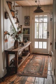 an entry way with a rug and vases on the floor in front of it