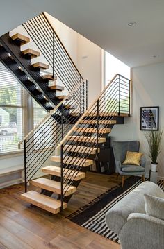 a living room filled with furniture and a stair case