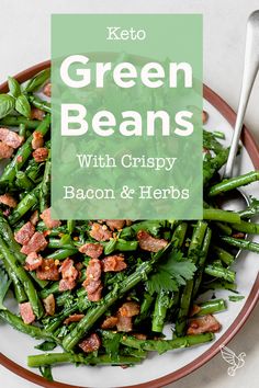 a white plate topped with green beans and bacon