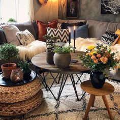 a living room filled with lots of furniture and flowers on top of a coffee table