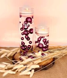 two candles sitting next to each other on top of a table