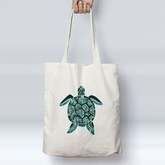 a person holding a white bag with a green sea turtle on it's side