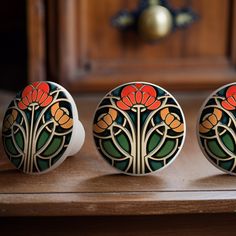 three decorative knobs sitting on top of a wooden table