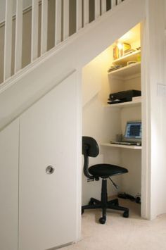 an open door leading to a desk with a laptop on it and a chair in the corner