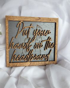 a wooden sign that says put your hands on the headboard