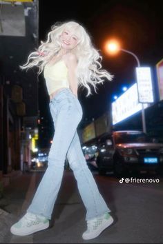 a woman walking down the street with her hair blowing in the wind