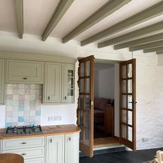 a kitchen with an open door leading to the living room