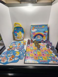 the children's care bears board game is on display with its matching case and accessories