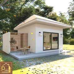 a small white house sitting on top of a lush green field