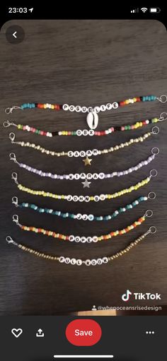 the beaded bracelets are on display in front of a wooden table with an iphone app