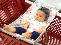 a baby is sitting in a shopping cart