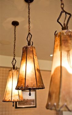 three lamps hanging from the ceiling in a room