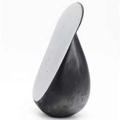 a black and white sculpture with a large oval shaped object in it's center