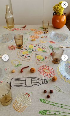 a table topped with glasses and vases filled with different types of items on top of it